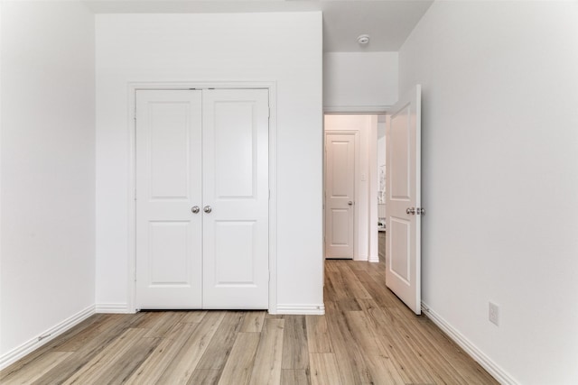 1233 Western Yarrow Ave, Justin, TX 76247 - unfurnished bedroom with light wood-style floors and a closet