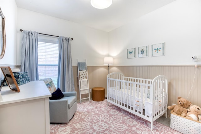 400 Patricia Ln, Highland Village, TX 75077 - bedroom featuring a wainscoted wall, light colored carpet, and a crib
