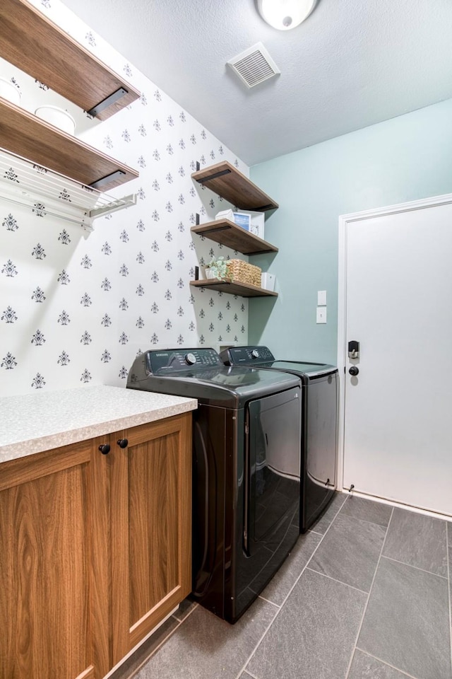 400 Patricia Ln, Highland Village, TX 75077 - laundry room with washer and clothes dryer, wallpapered walls, dark tile patterned floors, and cabinet space