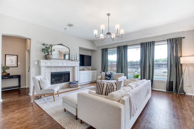 400 Patricia Ln, Highland Village, TX 75077 - living room with dark wood-style flooring, a chandelier, arched walkways, and a fireplace