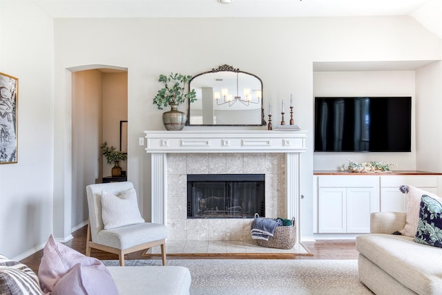 400 Patricia Ln, Highland Village, TX 75077 - living room with arched walkways, a chandelier, and a tiled fireplace