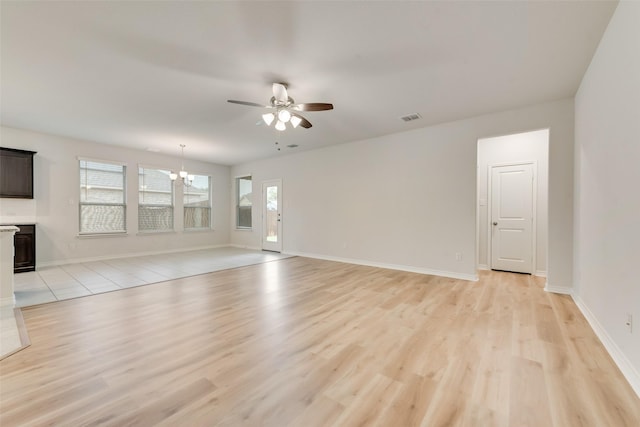 4003 Bendale Rd, Benbrook, TX 76116 - unfurnished living room with a ceiling fan, light wood-style floors, and a chandelier