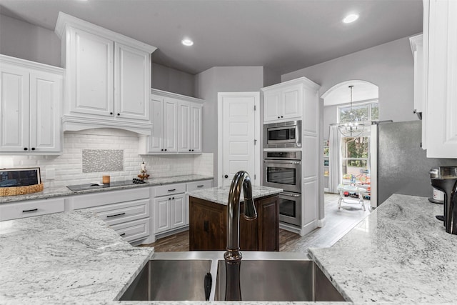 6202 Carrizo Dr, De Cordova, TX 76049 - kitchen featuring stainless steel appliances, white cabinetry, dark wood-style flooring, backsplash, and recessed lighting