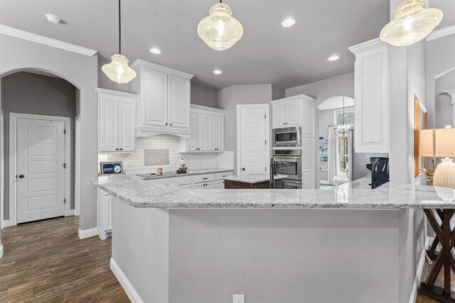 6202 Carrizo Dr, De Cordova, TX 76049 - kitchen featuring stainless steel microwave, black electric cooktop, arched walkways, tasteful backsplash, and white cabinets