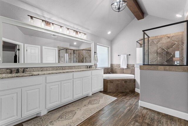 6202 Carrizo Dr, De Cordova, TX 76049 - bathroom featuring wood finished floors, a stall shower, a bath, double vanity, and recessed lighting