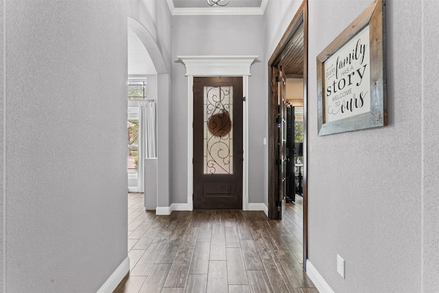 6202 Carrizo Dr, De Cordova, TX 76049 - entryway featuring a textured wall, wood finished floors, arched walkways, and crown molding