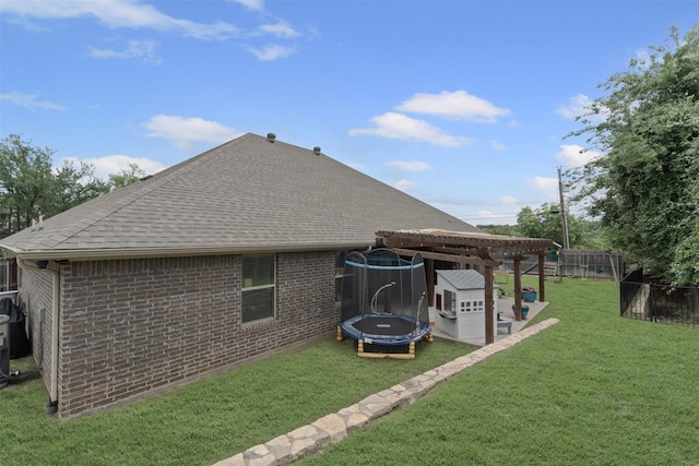 6202 Carrizo Dr, De Cordova, TX 76049 - rear view of house with a trampoline, roof with shingles, and brick siding