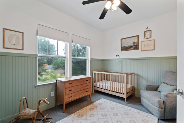 412 S Benge St, Mckinney, TX 75069 - bedroom featuring multiple windows, wainscoting, a crib, carpet flooring, and ceiling fan