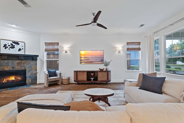 412 S Benge St, Mckinney, TX 75069 - living area featuring a stone fireplace, ceiling fan, ornamental molding, and wood finished floors