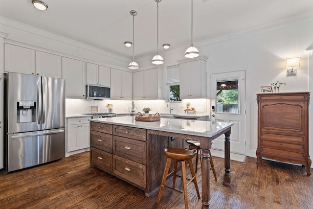 412 S Benge St, Mckinney, TX 75069 - kitchen with appliances with stainless steel finishes, a breakfast bar, dark wood finished floors, tasteful backsplash, and ornamental molding