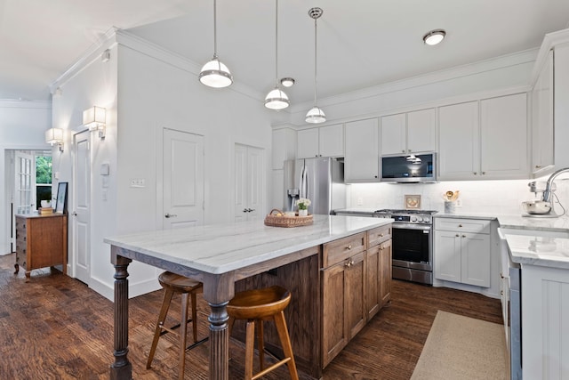 412 S Benge St, Mckinney, TX 75069 - kitchen with stainless steel appliances, crown molding, dark wood-style floors, a breakfast bar, and tasteful backsplash