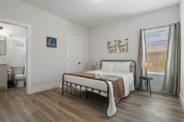 532 W Florence St, Denison, TX 75020 - bedroom with multiple windows, light wood-style flooring, and connected bathroom