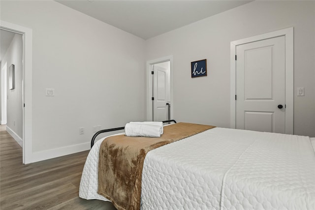 532 W Florence St, Denison, TX 75020 - bedroom with dark wood-style floors and baseboards