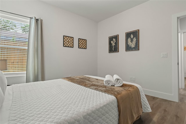 532 W Florence St, Denison, TX 75020 - bedroom with wood finished floors and baseboards