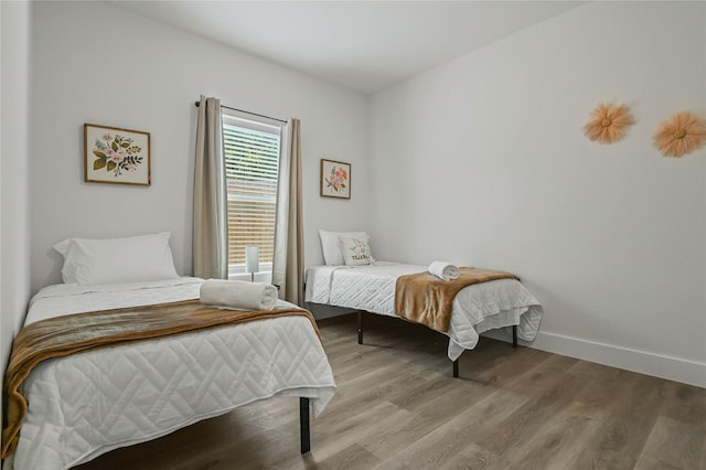 532 W Florence St, Denison, TX 75020 - bedroom with wood finished floors and baseboards