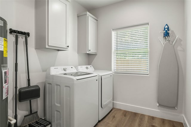532 W Florence St, Denison, TX 75020 - laundry room with washer and clothes dryer, cabinet space, light wood finished floors, and gas water heater
