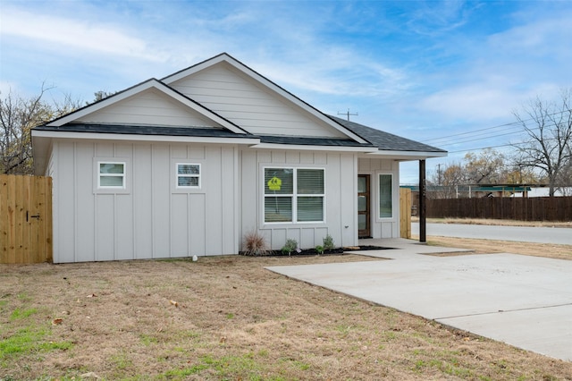 532 W Florence St, Denison, TX 75020 - view of front of property with board and batten siding, roof with shingles, and a patio area