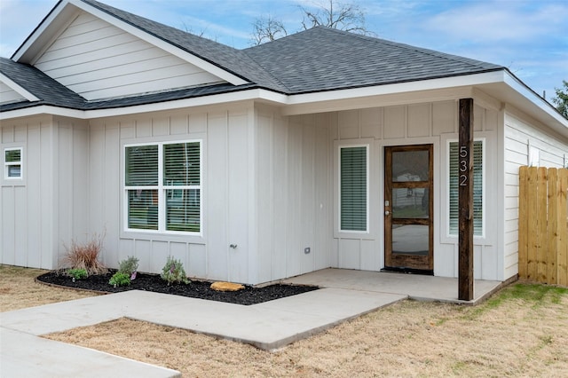 532 W Florence St, Denison, TX 75020 - property entrance featuring a shingled roof, a patio area, and board and batten siding