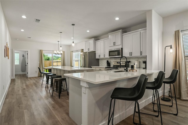 532 W Florence St, Denison, TX 75020 - kitchen featuring stainless steel appliances, tasteful backsplash, recessed lighting, light countertops, and a center island