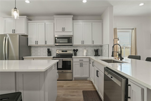 532 W Florence St, Denison, TX 75020 - kitchen featuring stainless steel appliances, recessed lighting, light countertops, light wood finished floors, and decorative backsplash