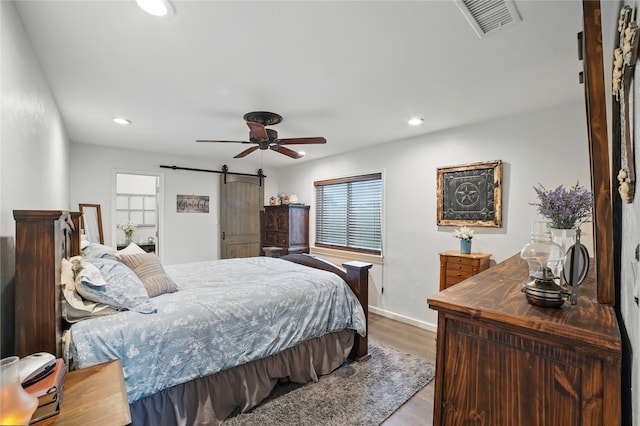 4328 Coryell Way, Mesquite, TX 75150 - bedroom with a barn door, wood finished floors, recessed lighting, and a ceiling fan
