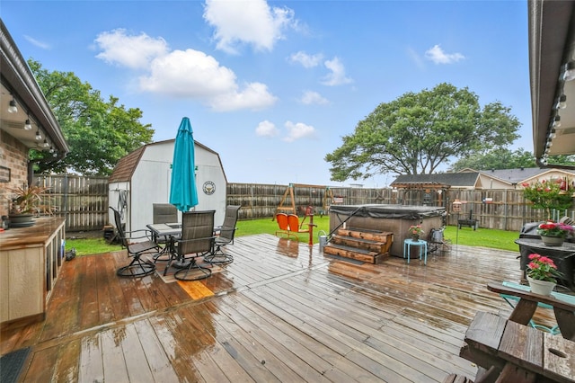 4328 Coryell Way, Mesquite, TX 75150 - deck featuring a hot tub, outdoor dining area, a fenced backyard, and a storage unit