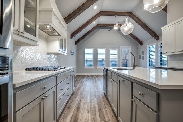 2238 Rook Dr, Dallas, TX 75211 - kitchen featuring stainless steel appliances, gray cabinets, custom exhaust hood, light wood-type flooring, and healthy amount of natural light