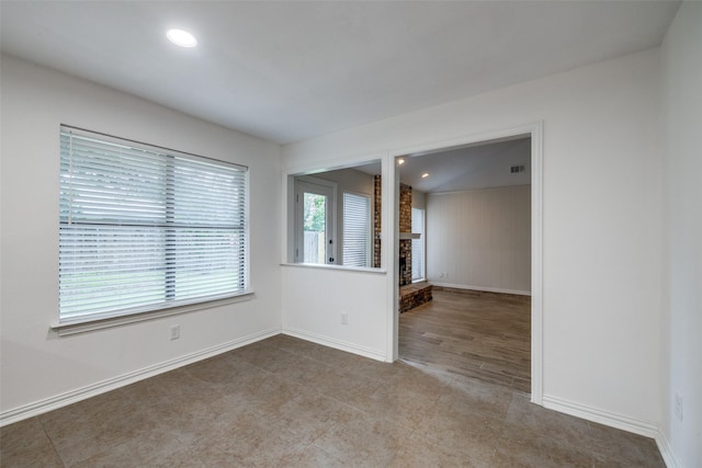 5125 Yucca Ct, Arlington, TX 76017 - empty room featuring a brick fireplace and recessed lighting