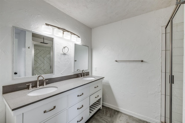 5125 Yucca Ct, Arlington, TX 76017 - full bathroom featuring double vanity, a shower stall, and a textured wall