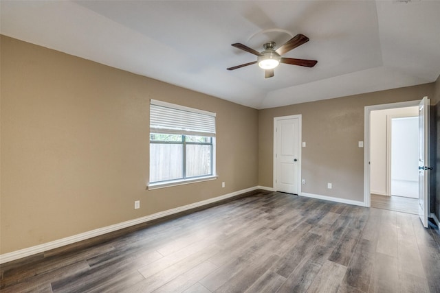 5125 Yucca Ct, Arlington, TX 76017 - unfurnished room with a ceiling fan, dark wood-style floors, and a tray ceiling