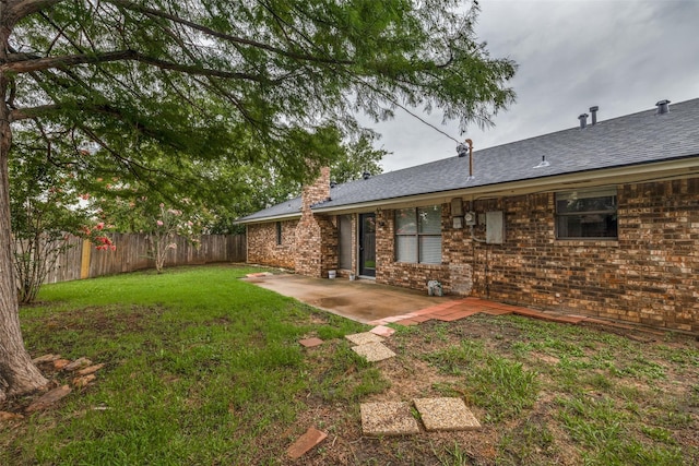 5125 Yucca Ct, Arlington, TX 76017 - back of house with a fenced backyard, a chimney, a patio, brick siding, and a shingled roof