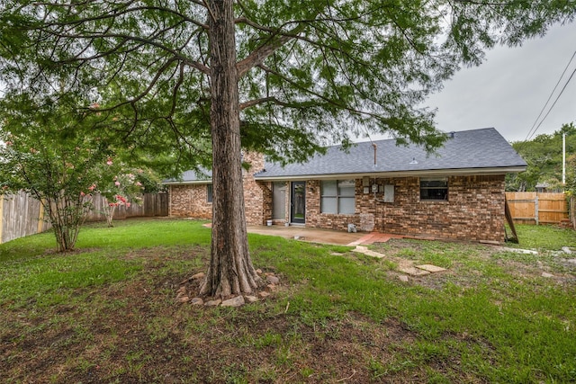 5125 Yucca Ct, Arlington, TX 76017 - back of property with a patio area, a fenced backyard, brick siding, and a shingled roof