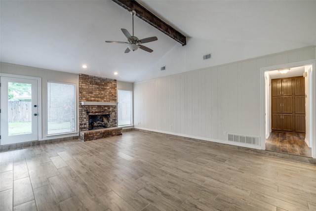 5125 Yucca Ct, Arlington, TX 76017 - unfurnished living room with a ceiling fan, wood finished floors, and a brick fireplace