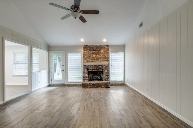 5125 Yucca Ct, Arlington, TX 76017 - unfurnished living room featuring vaulted ceiling, wood finished floors, a ceiling fan, and a fireplace