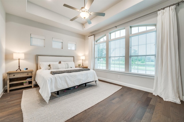 3418 River Trl, Frisco, TX 75034 - bedroom with a tray ceiling, dark wood finished floors, and a ceiling fan