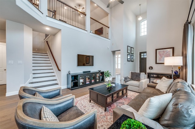 3418 River Trl, Frisco, TX 75034 - living room with a high ceiling, wood finished floors, stairs, and a ceiling fan