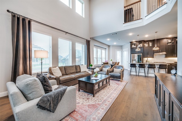 3418 River Trl, Frisco, TX 75034 - living area with light wood-style flooring and healthy amount of natural light