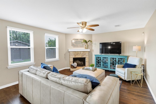 1837 Trego Dr, Fort Worth, TX 76247 - living area featuring dark wood-style floors, a ceiling fan, and a stone fireplace