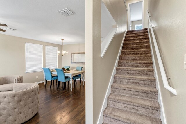 1837 Trego Dr, Fort Worth, TX 76247 - stairway featuring wood finished floors, a chandelier, and a ceiling fan