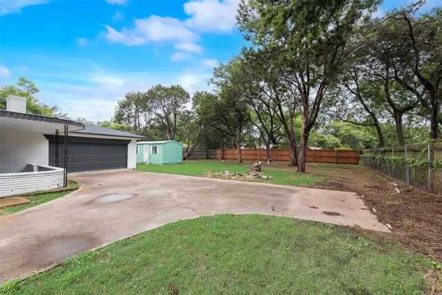 523 Frank Keasler, Duncanville, TX 75116 - view of yard featuring concrete driveway and an outdoor structure