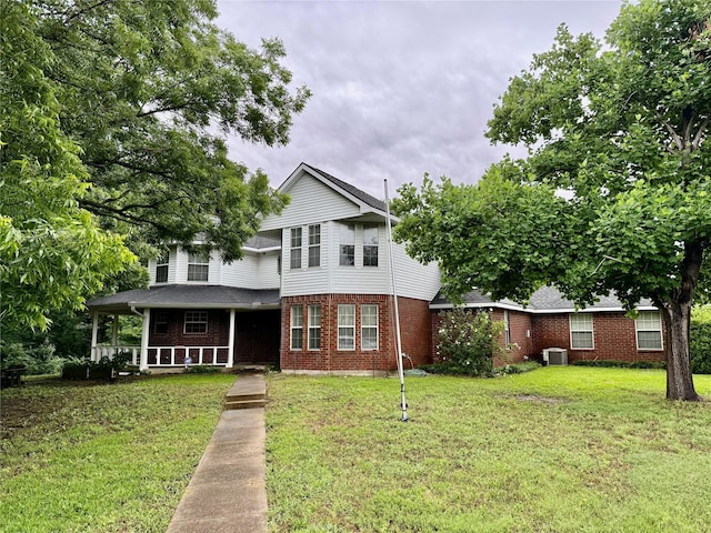 2909 Troy Rd, Wylie, TX 75098 - view of front of property featuring a porch, brick siding, a front yard, and a shingled roof