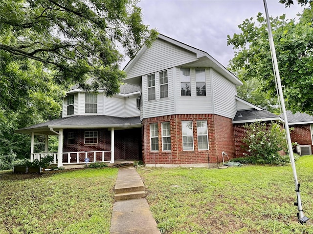 2909 Troy Rd, Wylie, TX 75098 - view of front of house featuring brick siding, a porch, a front yard, and a shingled roof