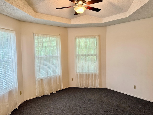 2909 Troy Rd, Wylie, TX 75098 - empty room with a raised ceiling, ceiling fan, dark carpet, and a textured ceiling