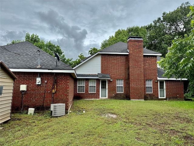 2909 Troy Rd, Wylie, TX 75098 - rear view of house with roof with shingles, a lawn, a chimney, and brick siding