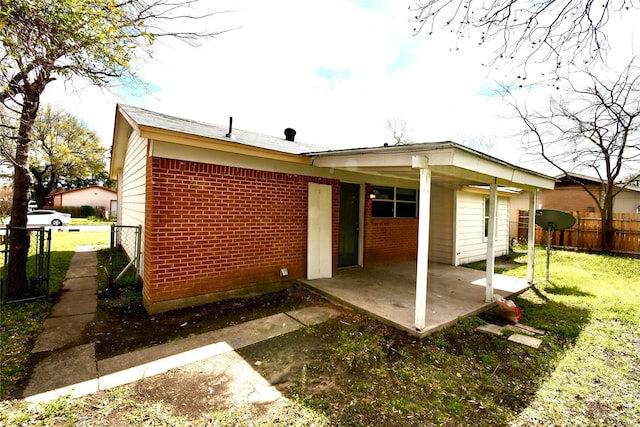 2625 Fairbrook St, Irving, TX 75062 - back of house featuring brick siding and a patio area