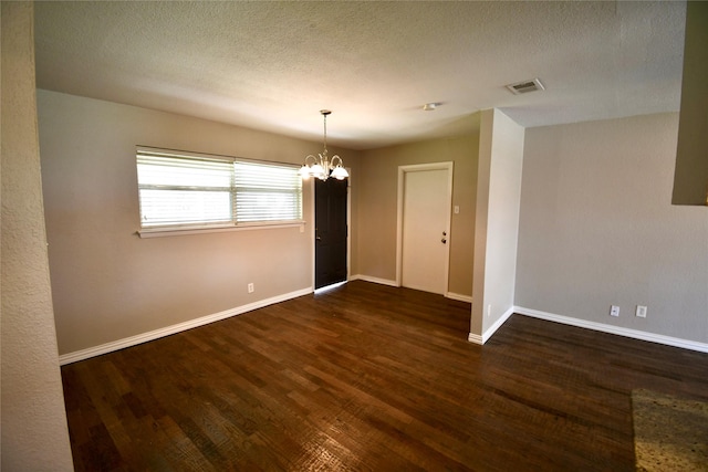 2625 Fairbrook St, Irving, TX 75062 - unfurnished room featuring a chandelier, wood finished floors, and a textured ceiling