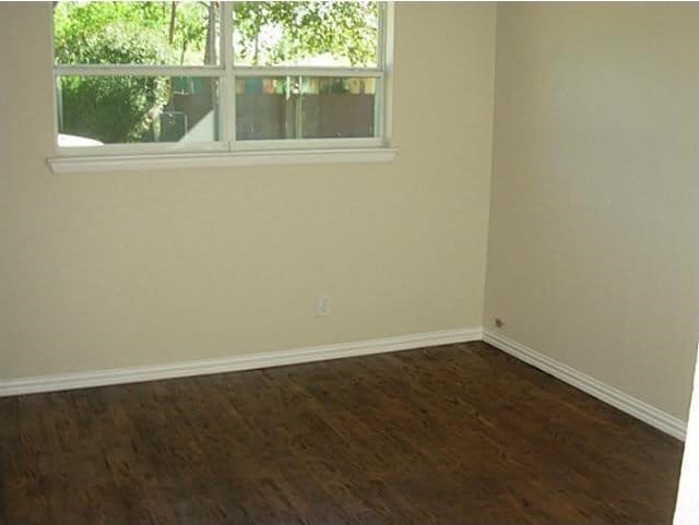 2625 Fairbrook St, Irving, TX 75062 - spare room featuring dark wood finished floors