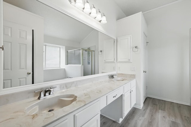 1800 Chatham Dr, Flower Mound, TX 75028 - bathroom featuring a stall shower, double vanity, wood finished floors, and lofted ceiling