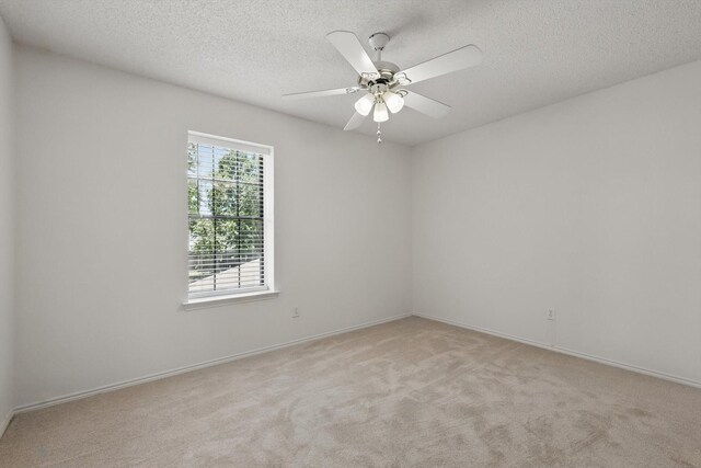 1800 Chatham Dr, Flower Mound, TX 75028 - empty room with a textured ceiling, light colored carpet, and a ceiling fan