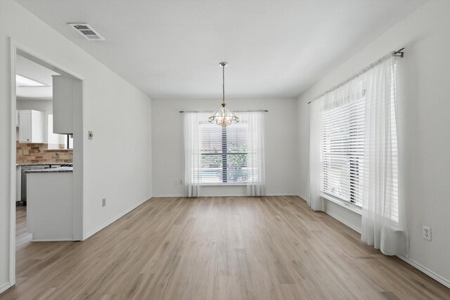 1800 Chatham Dr, Flower Mound, TX 75028 - unfurnished dining area with a chandelier and light wood-type flooring
